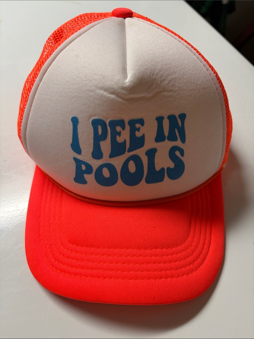 Kids Neon Orange Trucker Hat with 'I PEE IN POOLS' Print